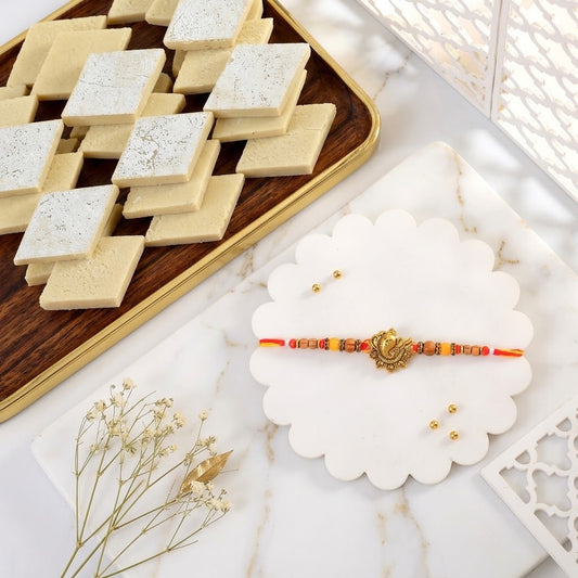 Divine Golden Ganesha Rakhi with Kaju Katli