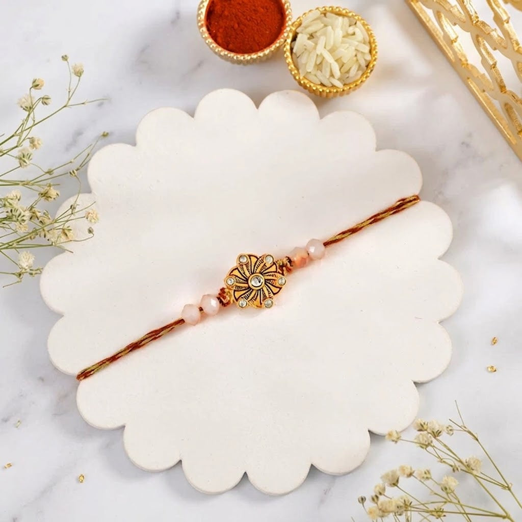 Timeless Golden Flower Rakhi with Besan Laddu & Ferrero Rocher
